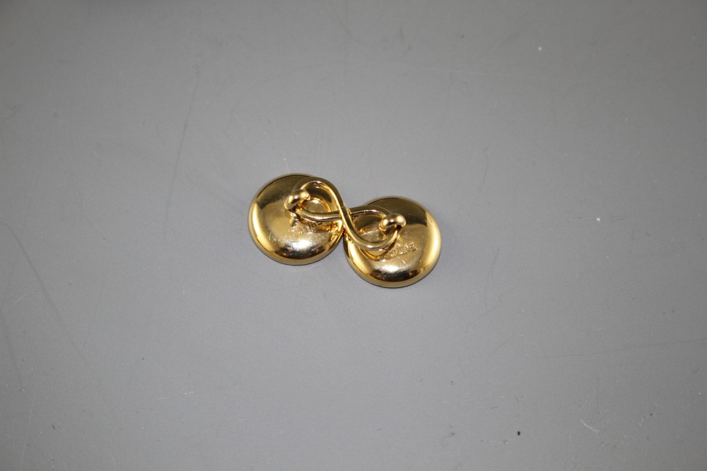 A pair of yellow metal (stamped TM 18ct), mother of pearl and enamel disc cufflinks, gross weight 10 grams, disc 14mm.